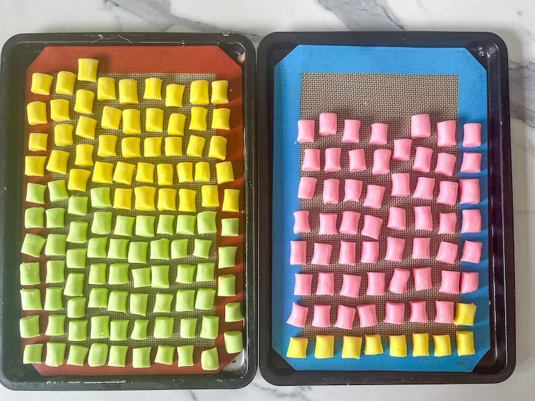 Two small trays with rows of pastel colored butter mints