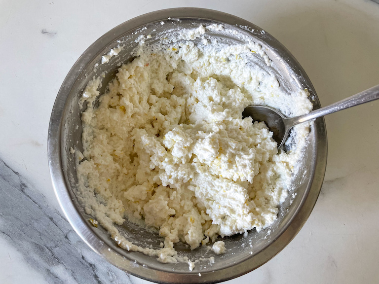 Bowl of whipped ricotta with a spoon