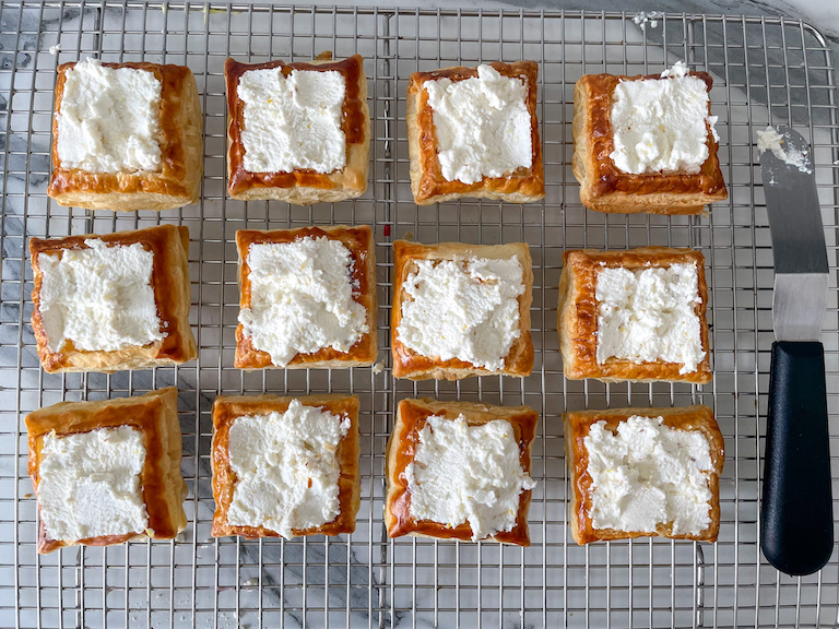 Squares of ricotta puff pastry on a wire rack