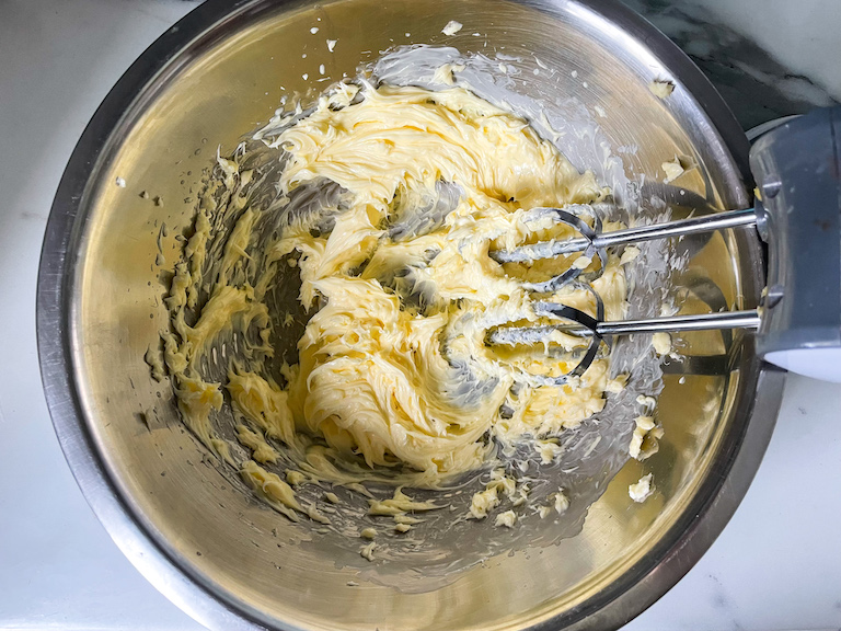 Whipped butter in a bowl with hand mixer