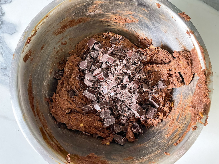 Adding chopped chocolate to metal bowl
