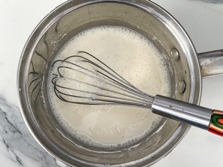 Whisk in saucepan with milk