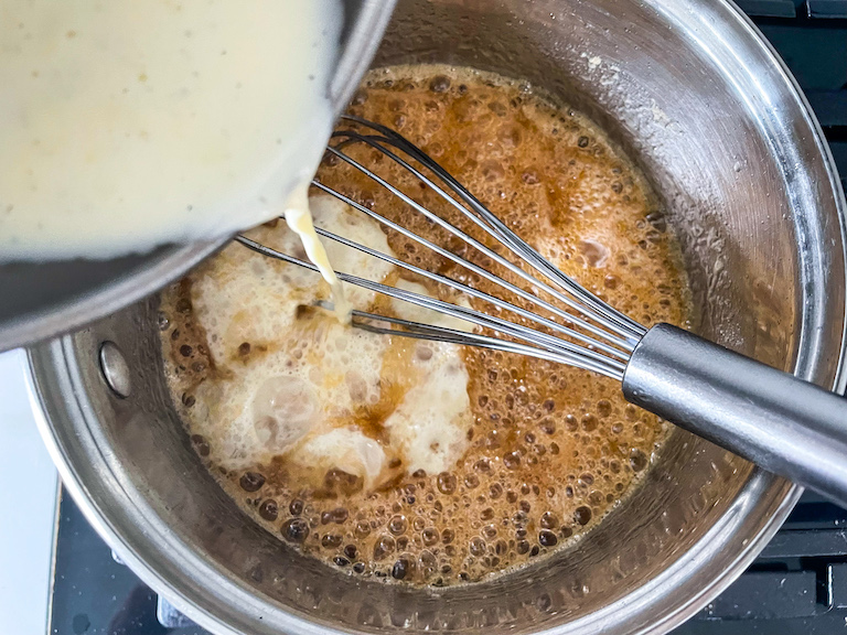 Pouring cream into hot caramel mixture