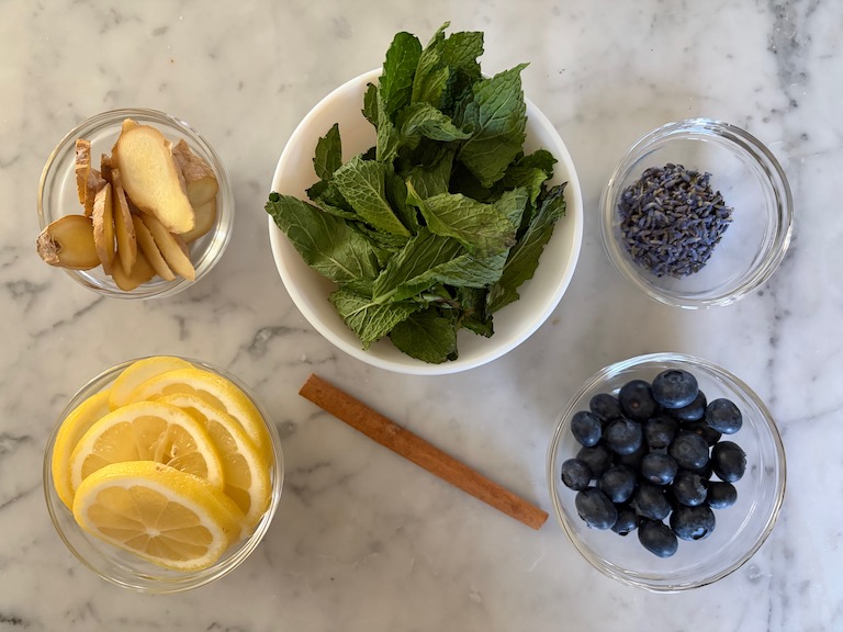 Ingredients for making a spring simmer pot, arranged on a marble surface