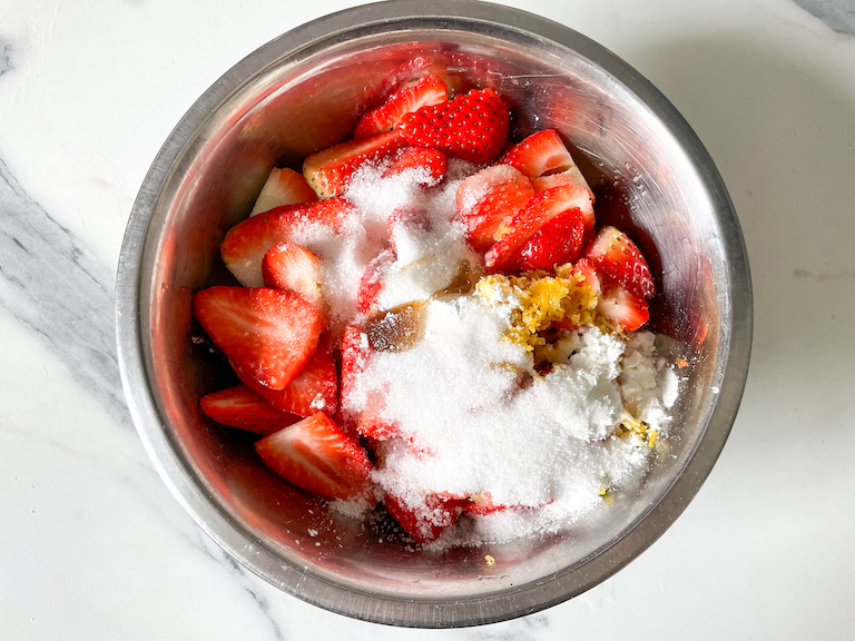 Strawberry galette filling ingredients in a metal bowl