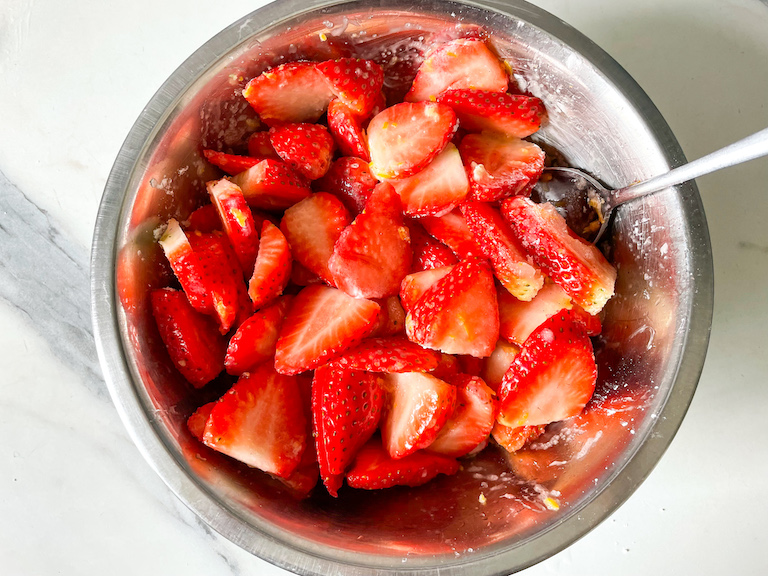 Strawberries in a bowl with a spoon