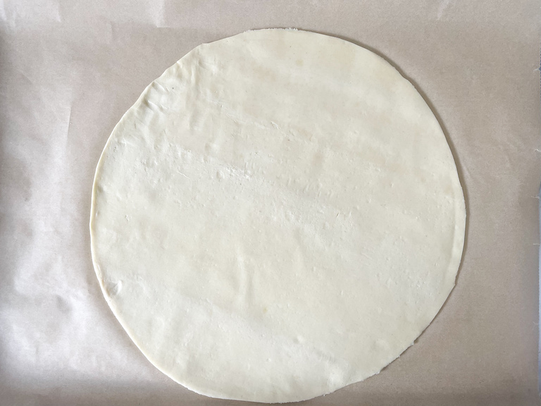 Circle of pastry on a sheet of parchment