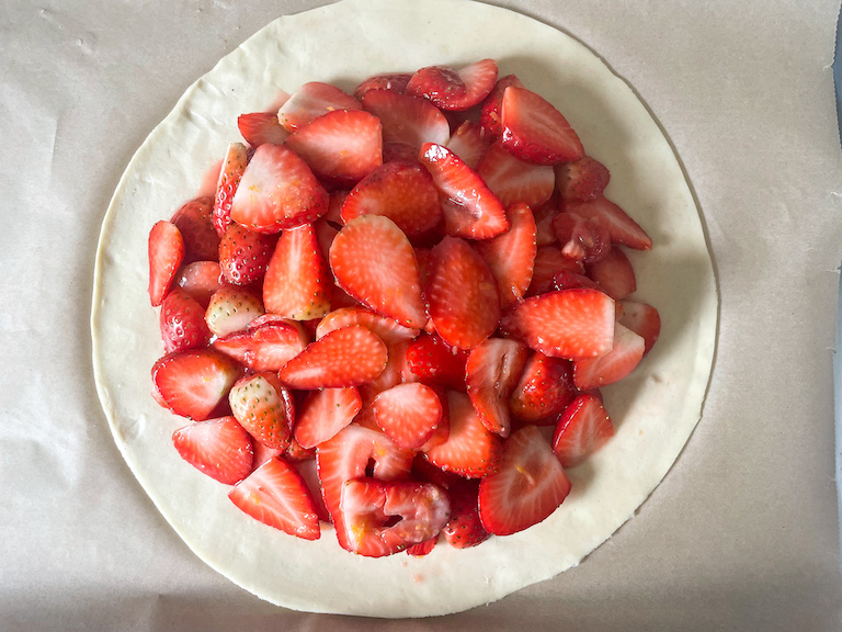Strawberries piled on a disc of pastry