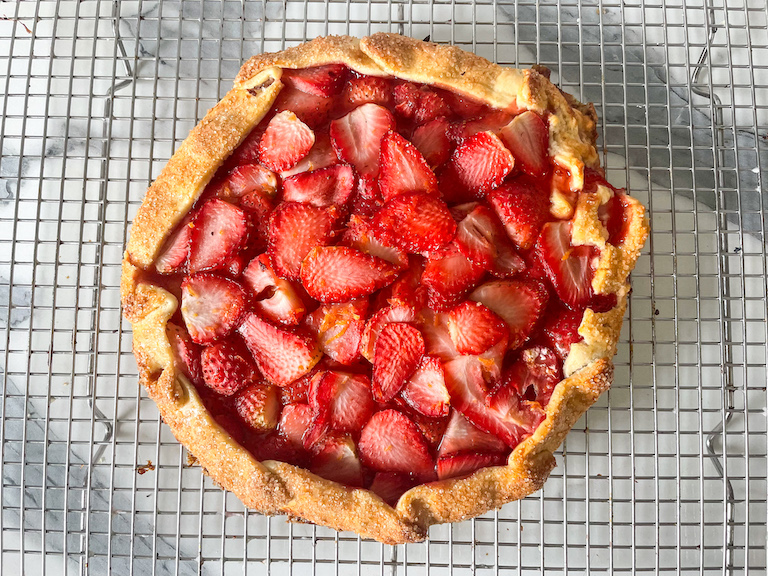 Baked strawberry galette on a wire cooling rack