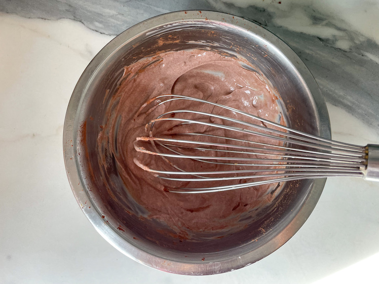 Chocolate yogurt in a bowl with a whisk