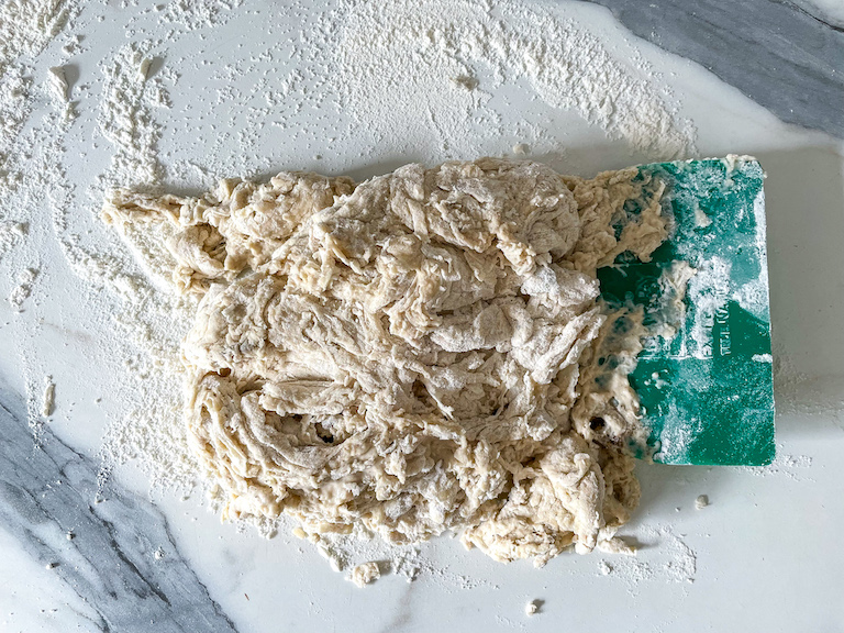 Dough on countertop with scraper