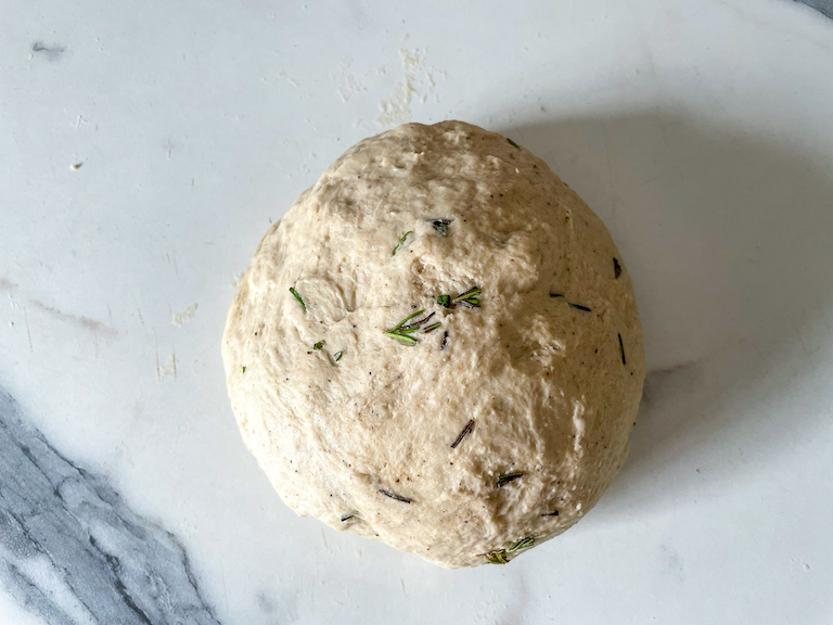 Ball of bread dough on marble counter