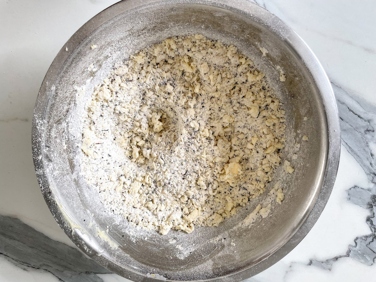 Crumbled shortbread mixture in a metal bowl