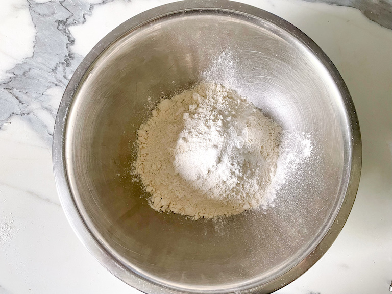 A metal bowl of flour