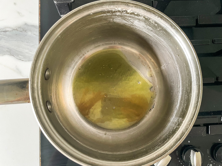 Olive oil in a small saucepan on a stovetop