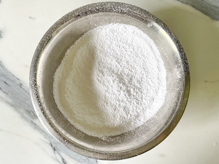Confectioner's sugar in a metal bowl