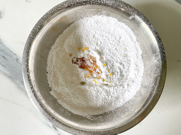 Confectioner's sugar in a bowl with golden syrup