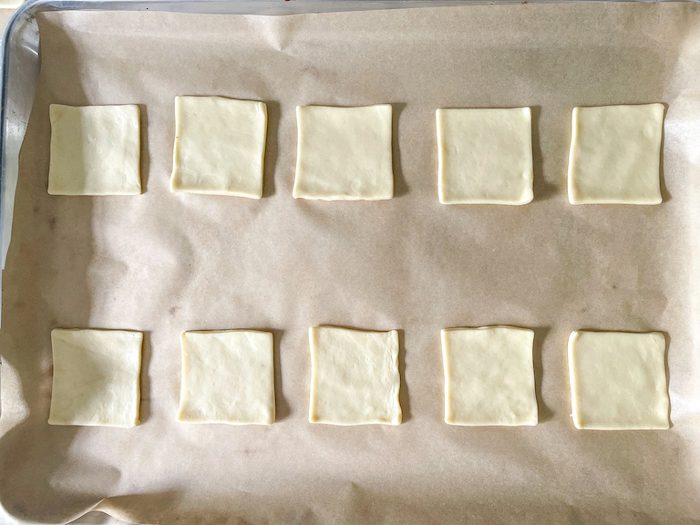 Squares of pastry on parchment lined tray