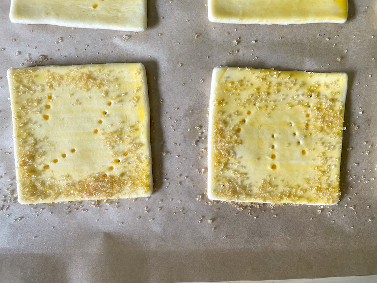 Squares of puff pastry sprinkled with coarse Demerara sugar