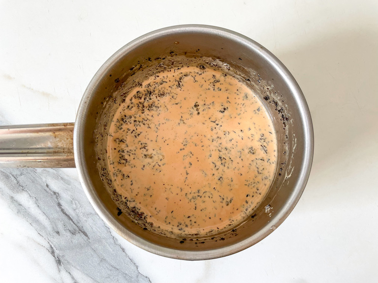 A saucepan of cream infused with Earl Grey tea