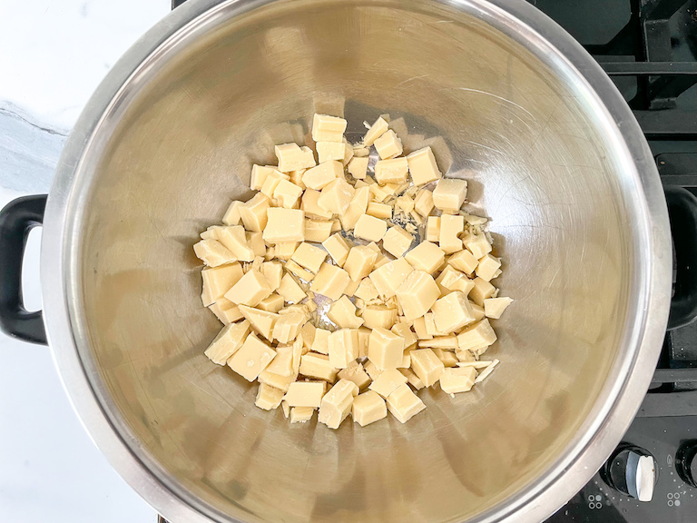 A bowl of chopped white chocolate in a bain marie on the stovetop