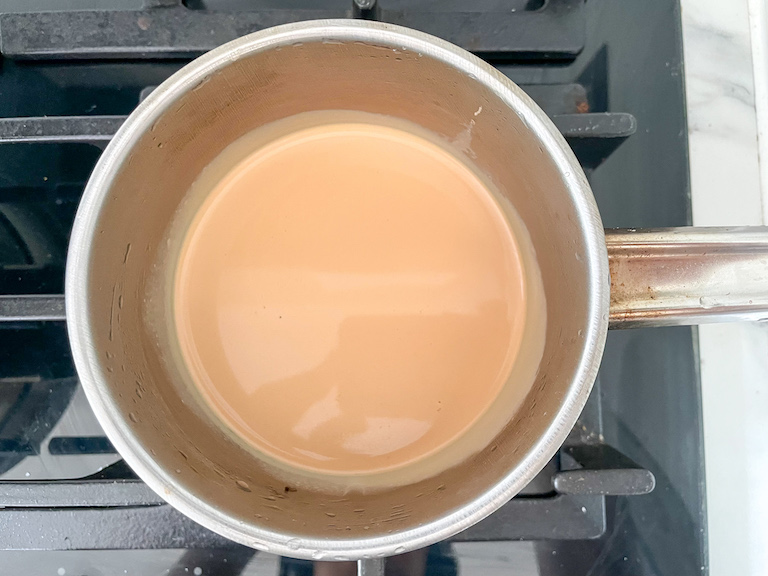 A saucepan of tea-infused cream on a stovetop