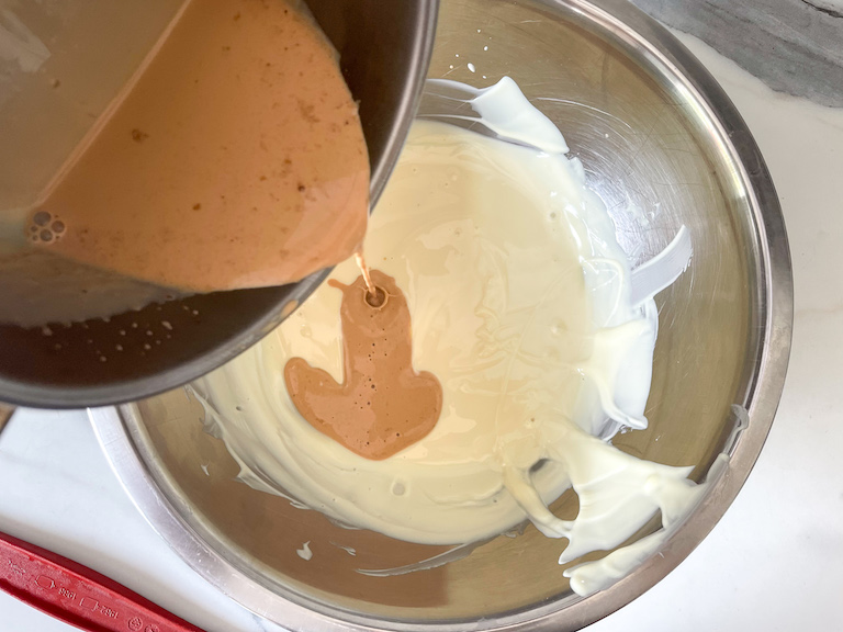 Pouring cream into melted white chocolate