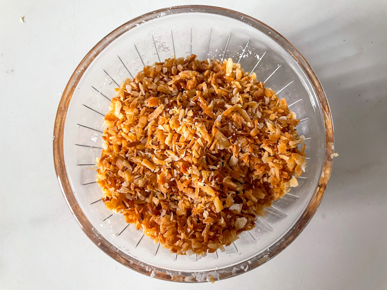A small glass dish of toasted coconut