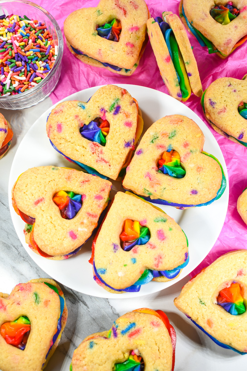 A plate of buttercream rainbow sandwich cookies