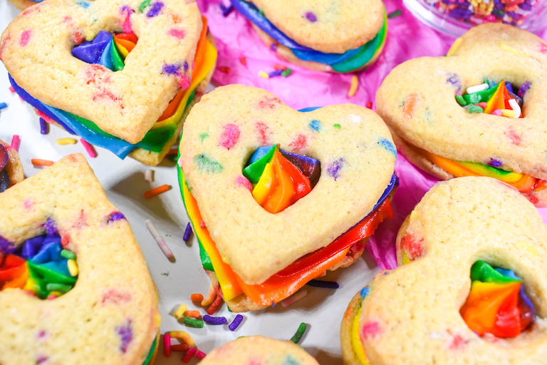Rainbow heart cookies on a sheet of pink tissue