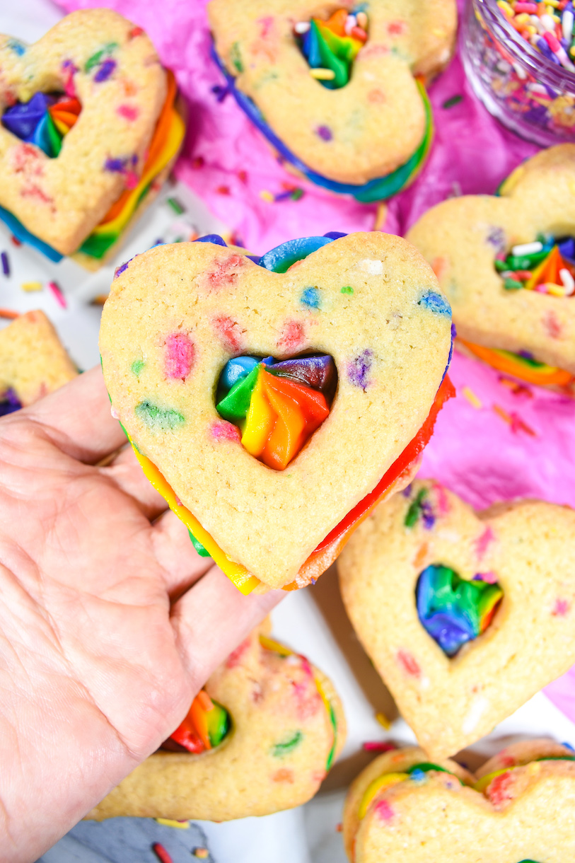 Hand holding a rainbow Pride cookie