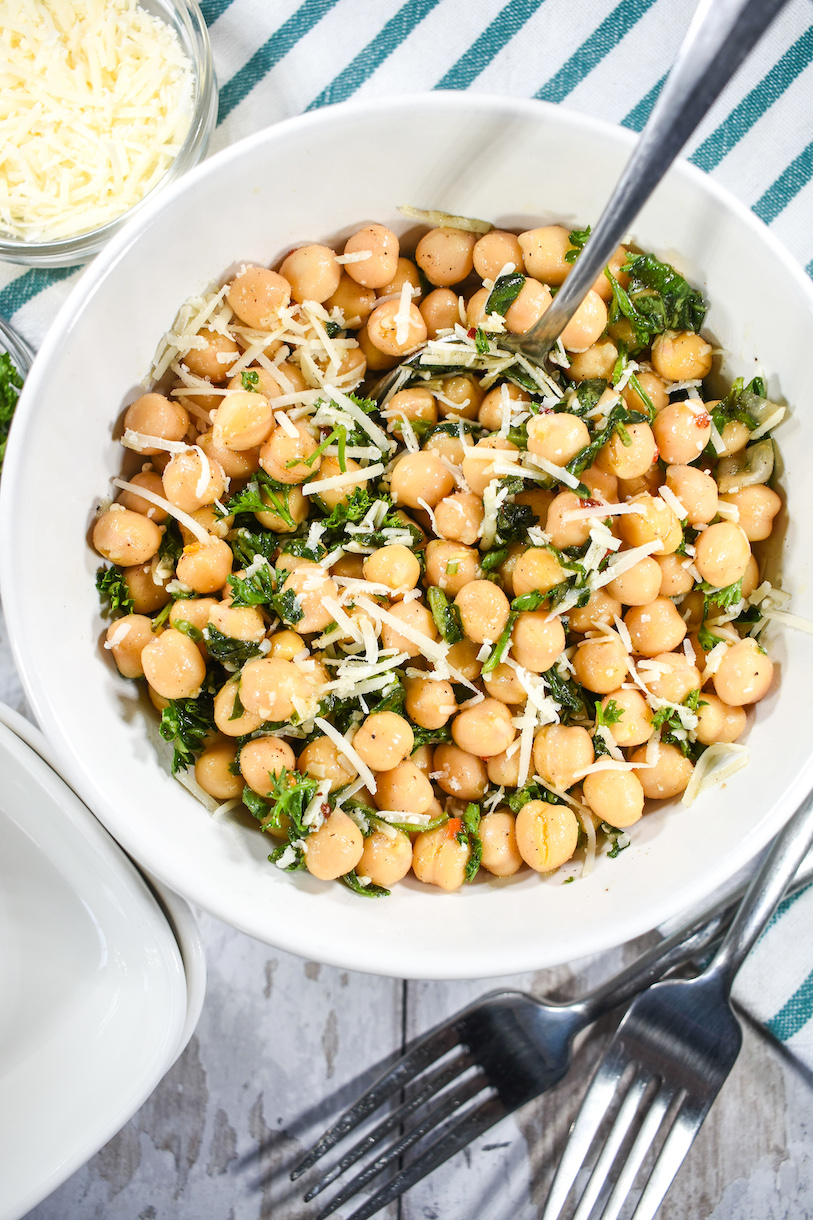 A bowl of chickpea salad with a spoon