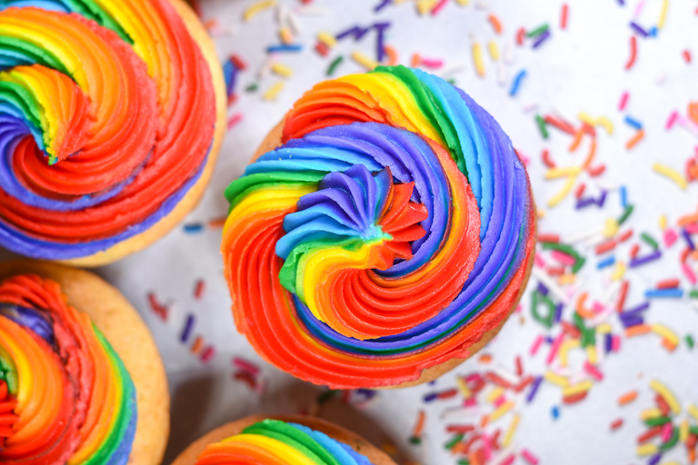 A rainbow cupcake and rainbow sprinkles