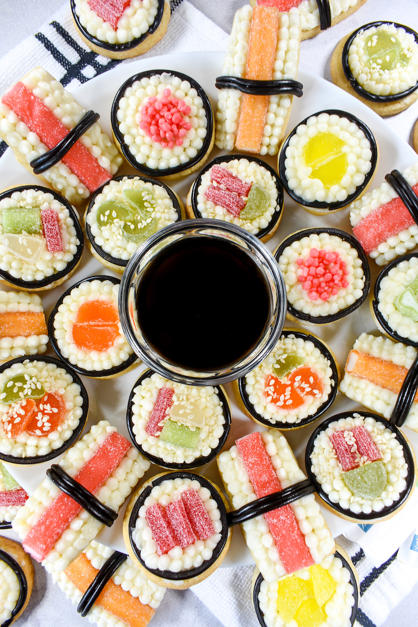 sushi cookies arranged on a plate around a dish of soy sauce
