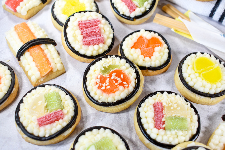 Buttercream sushi sugar cookies on a white surface