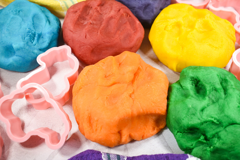 Balls of homemade playdough and cookie cutters