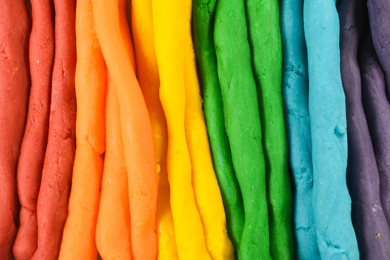 A rainbow of strips of homemade playdough