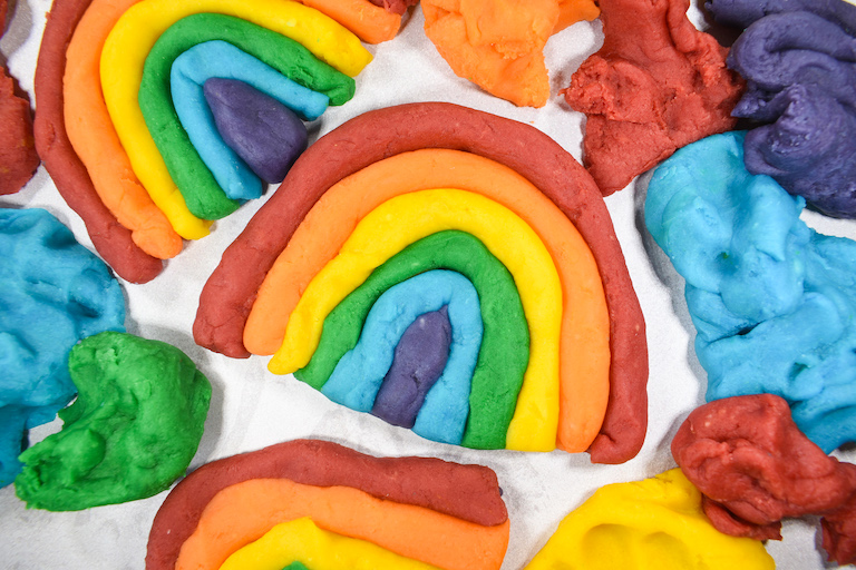 Rainbows shaped from strips of homemade play dough