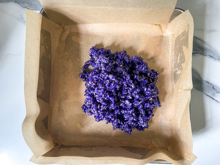 Purple krispie mixture in a tin