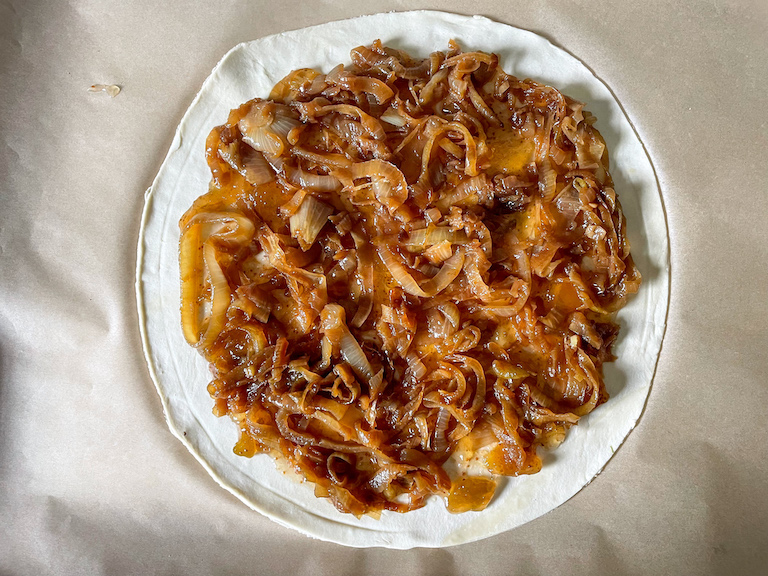 caramelised onions arranged on a disc of puff pastry