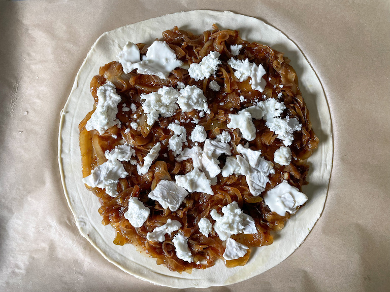 Caramelised onions and goat cheese on a disc of puff pastry