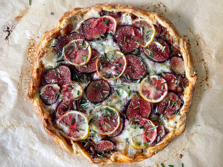 Fig and goat's cheese tart with fresh herbs on top