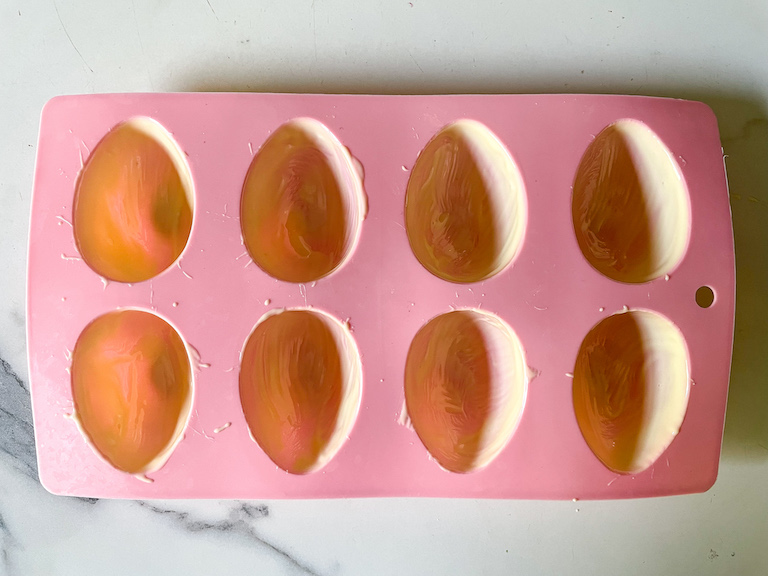 Pink egg mould brushed with white chocolate