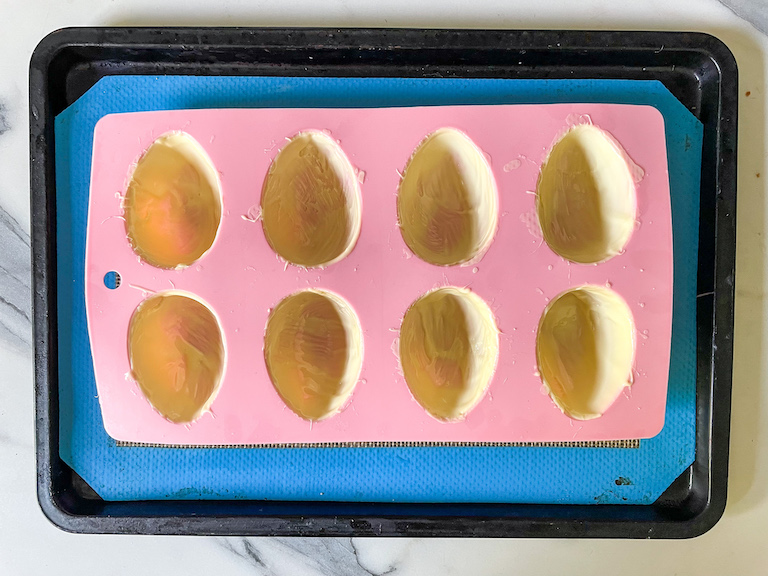 Silicone egg mould brushed with white chocolate