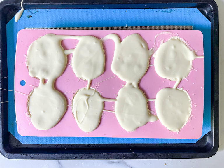 Egg mold filled with melted white chocolate