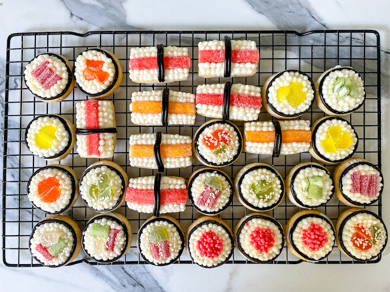 Decorated sushi cookies on a wire rack
