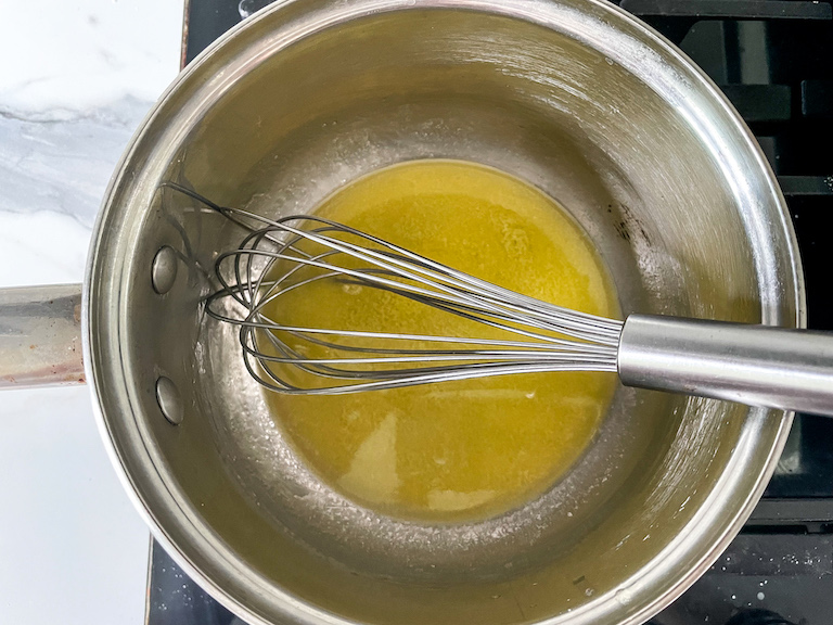 Melted butter in a pan with a whisk