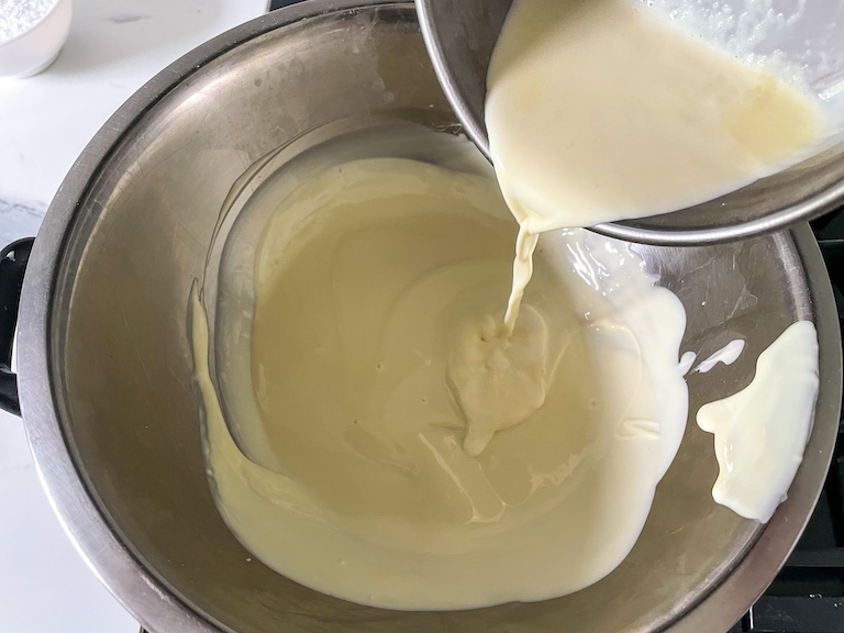 Pouring cream into melted white chocolate