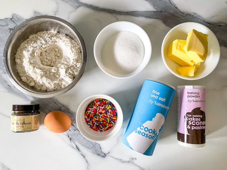 Ingredients for making a buttercream rainbow cookie recipe