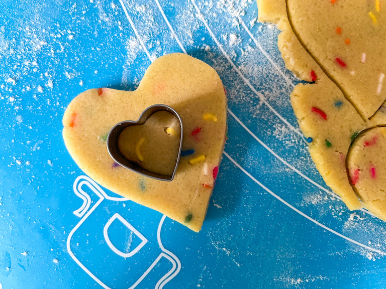 Mini heart cutter cutting cookie dough